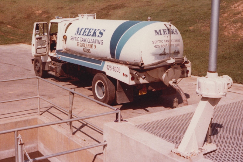 Vintage photo of an early Meeks septic truck at a treatment plant, circa 1978